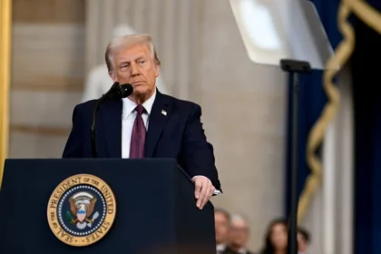 Donald Trump speaking at a White House podium during official address on Truth Social and national security